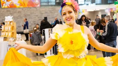 A woman in a yellow flower costume.