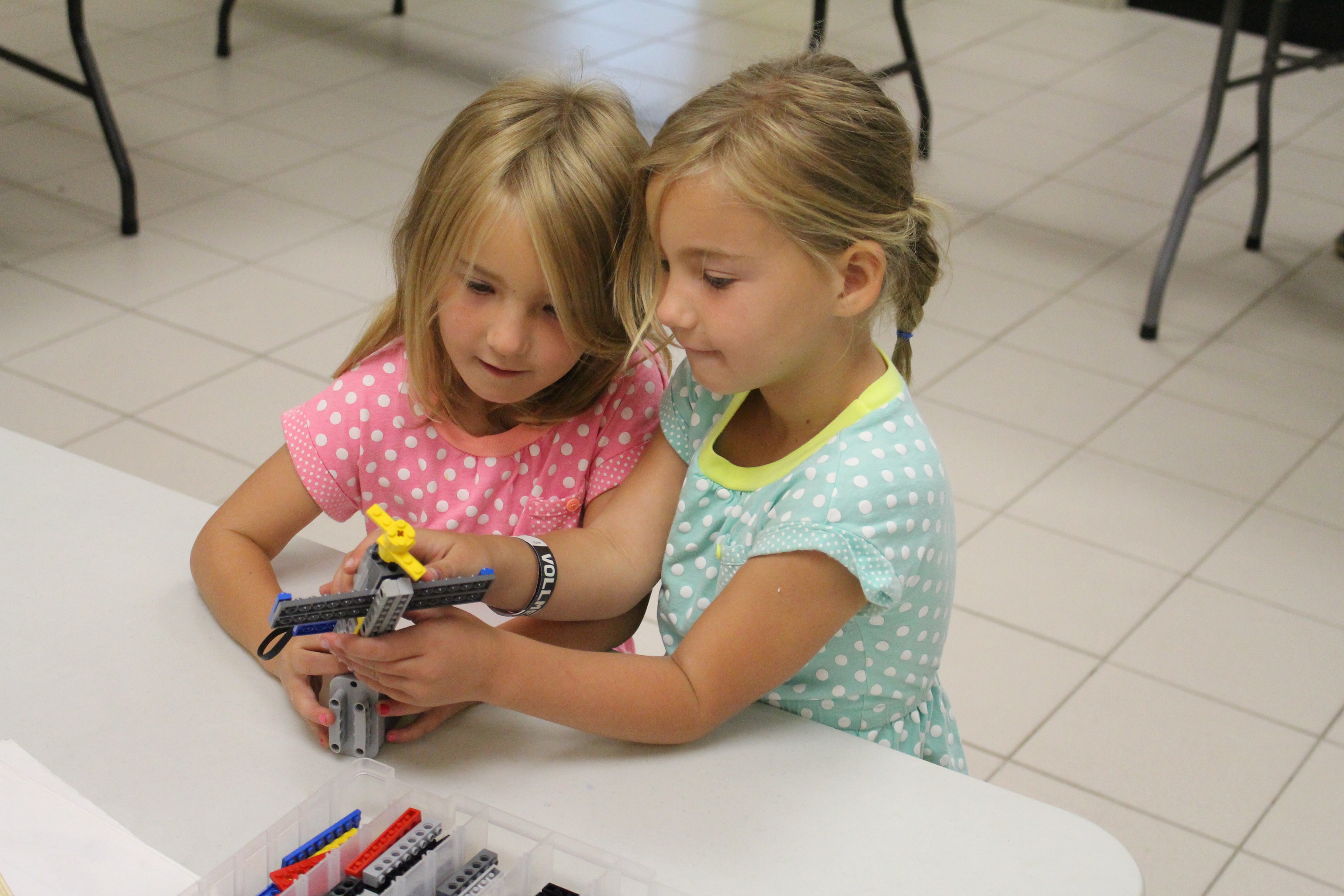Sisters at Vollmer Daycare building with legos