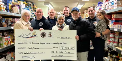 people holding a large cheque