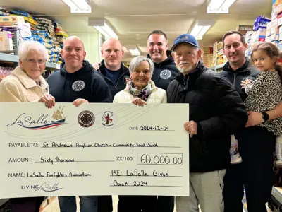 people holding a large cheque