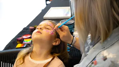 Child getting their face painted.